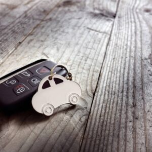 A car key chain with a remote on top of it.