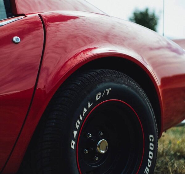 A close up of the wheel on a red car