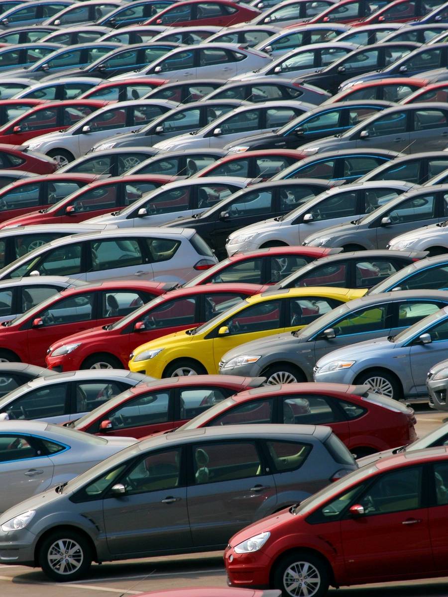 A large group of cars parked in a lot.