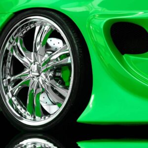 A close up of the wheel on a green car