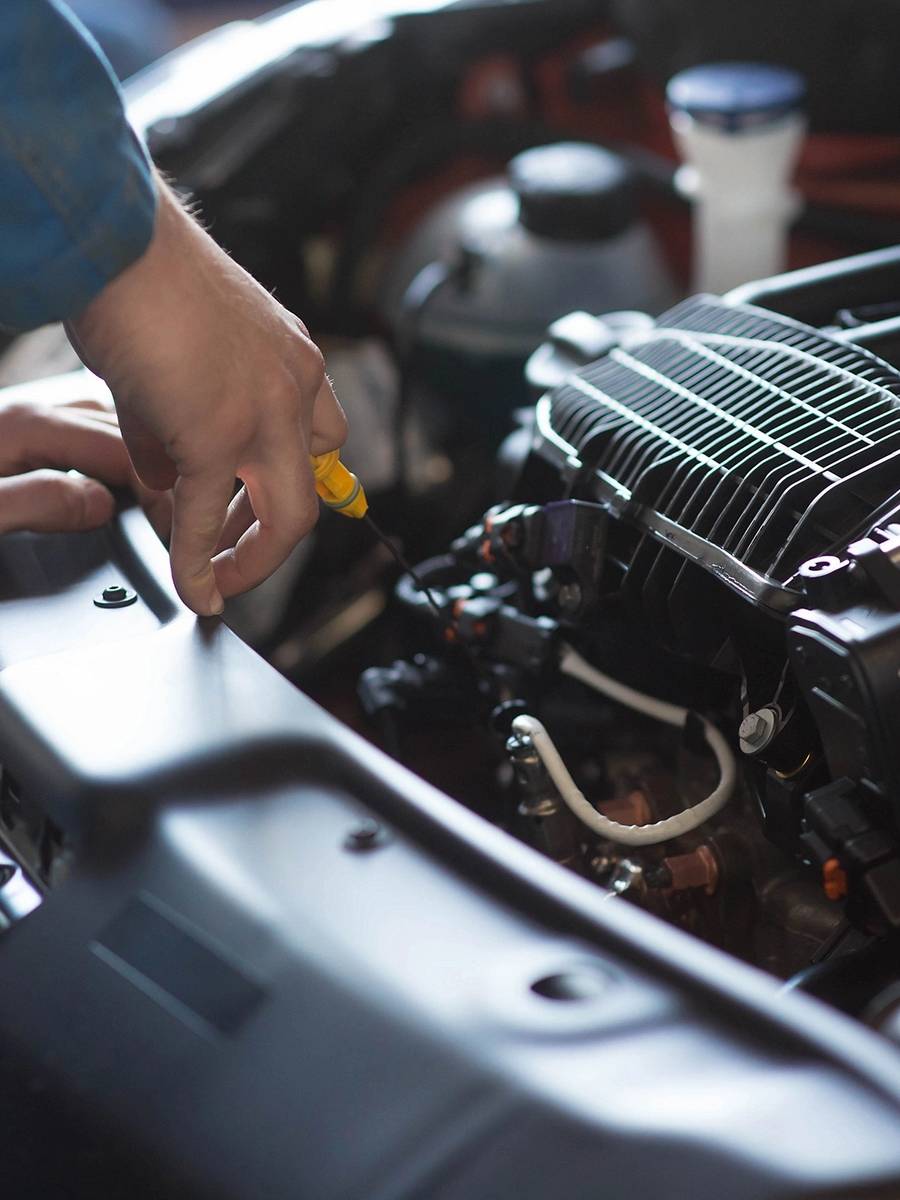 A person working on an engine in a garage.