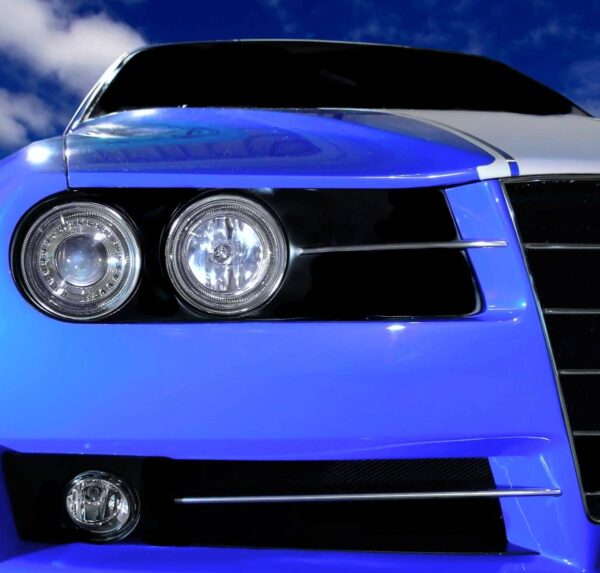 A close up of the front end of a blue car