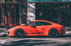 A red car parked on the side of a road.